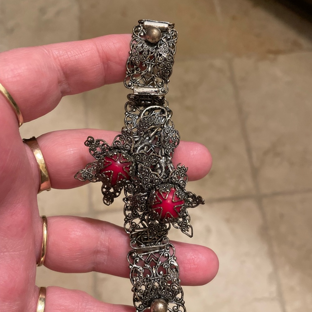 Antique silver color but testing as 14K. Filigree 7”bracelet 2 red colored pearl